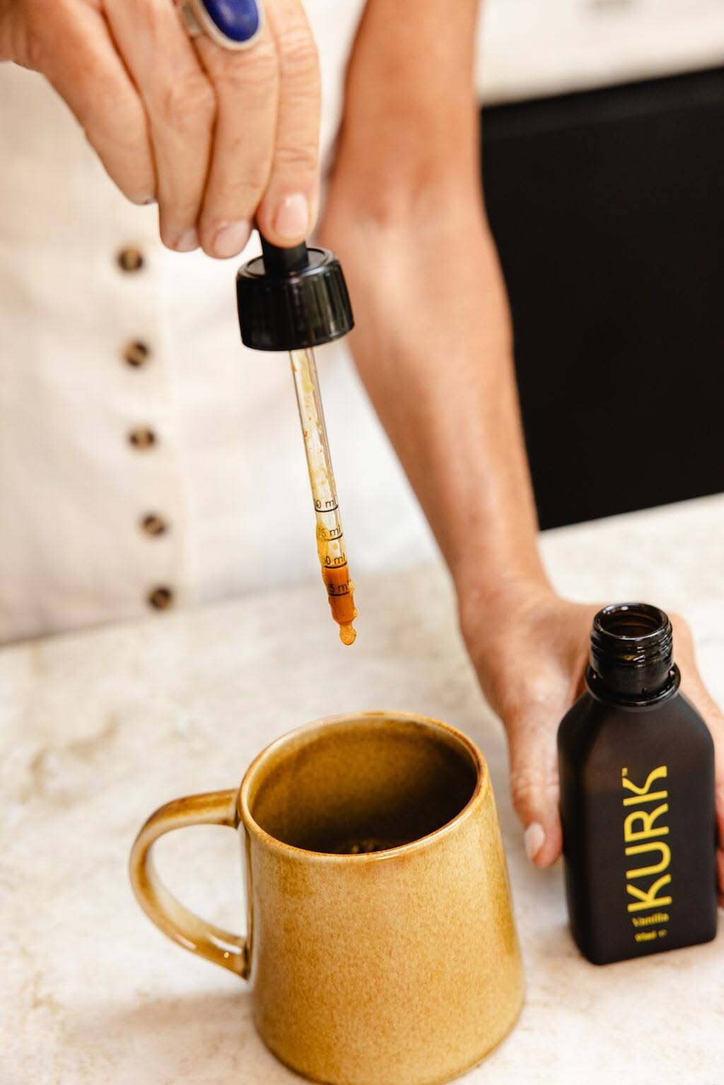 KURK dropper above a mug beside the bottle